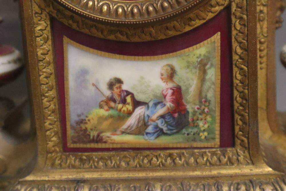 A 19th century French Louis XV style gilt spelter and porcelain mounted eight day mantel clock, on plinth, under a glass dome, with pen